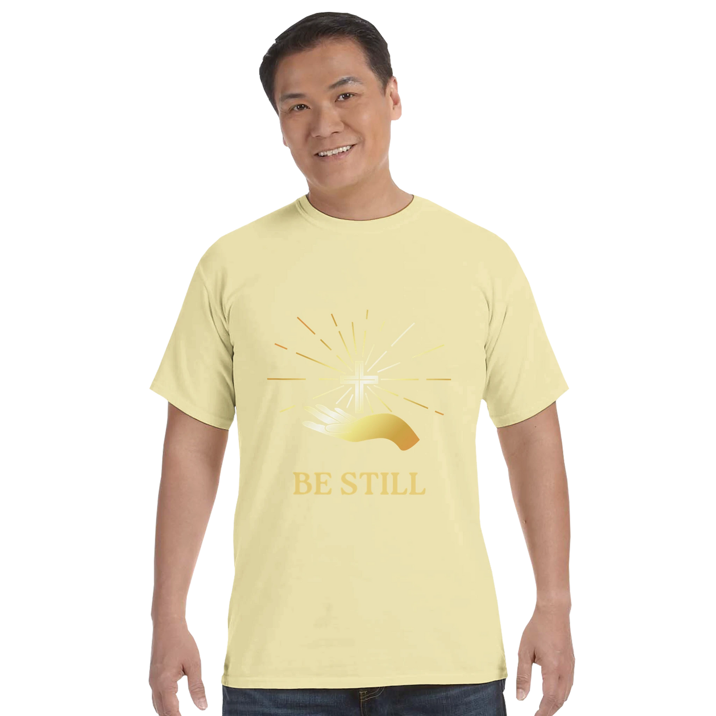 Christian graphic t-shirt featuring a shining cross design with the words Be Still