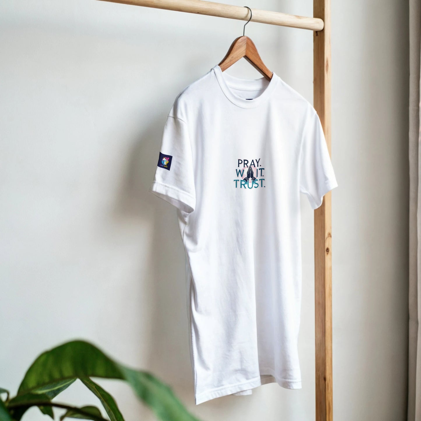 White Christian inspirational t-shirt with the message Pray, Want, Trust displayed on the front