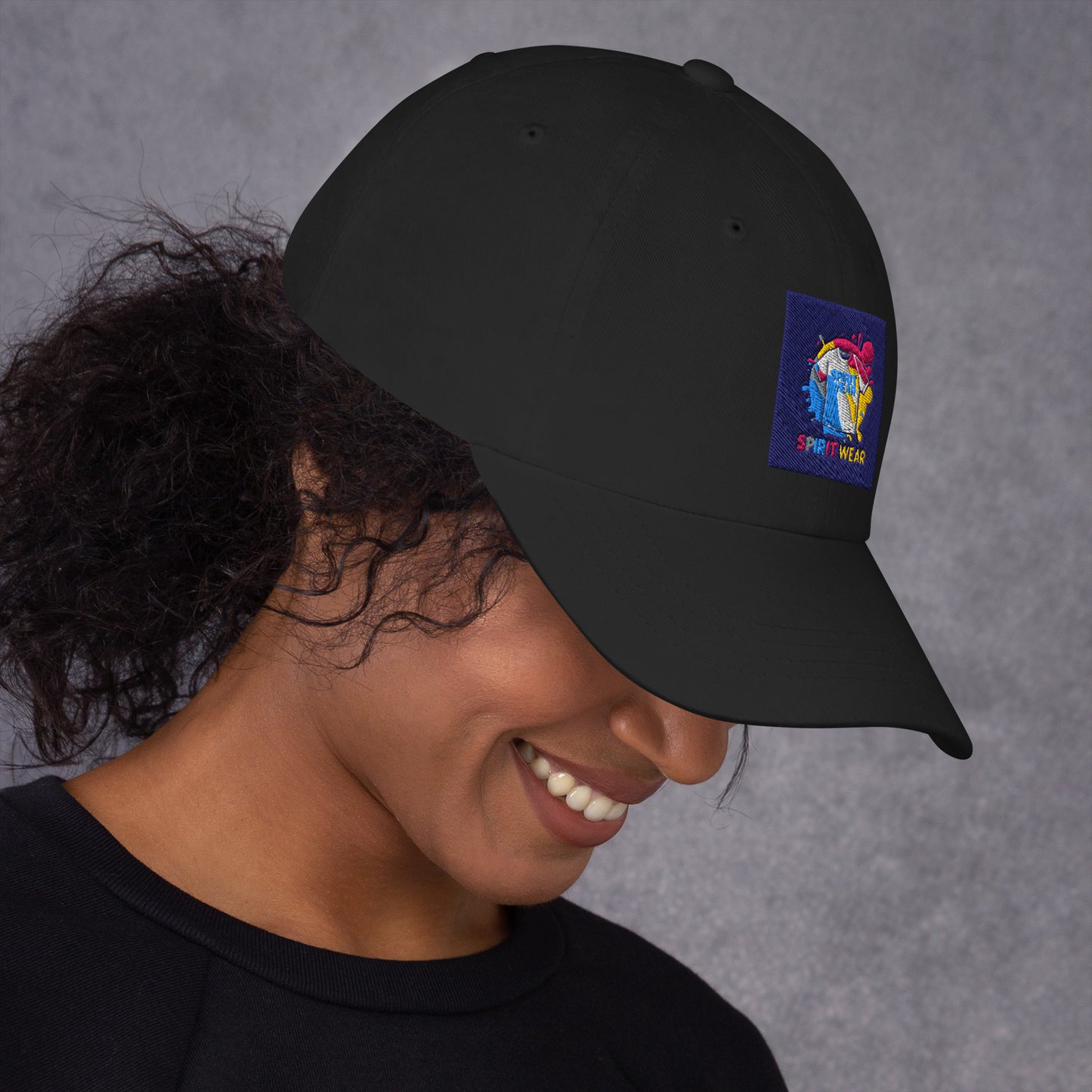 Black Christian ball cap by Spirit Wear with colorful embroidered logo worn by smiling woman