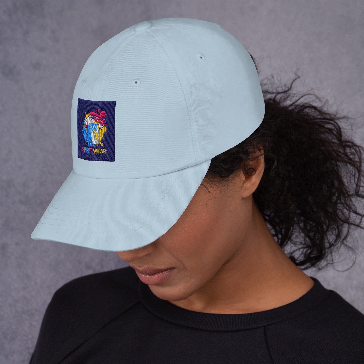 Light blue Christian ball cap by Spirit Wear with colorful embroidered logo worn by woman