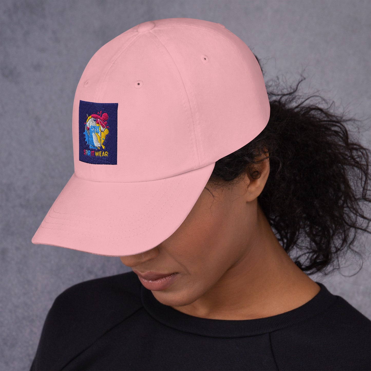 Spirit Wear pink Christian ball cap with embroidered logo worn by woman with dark hair