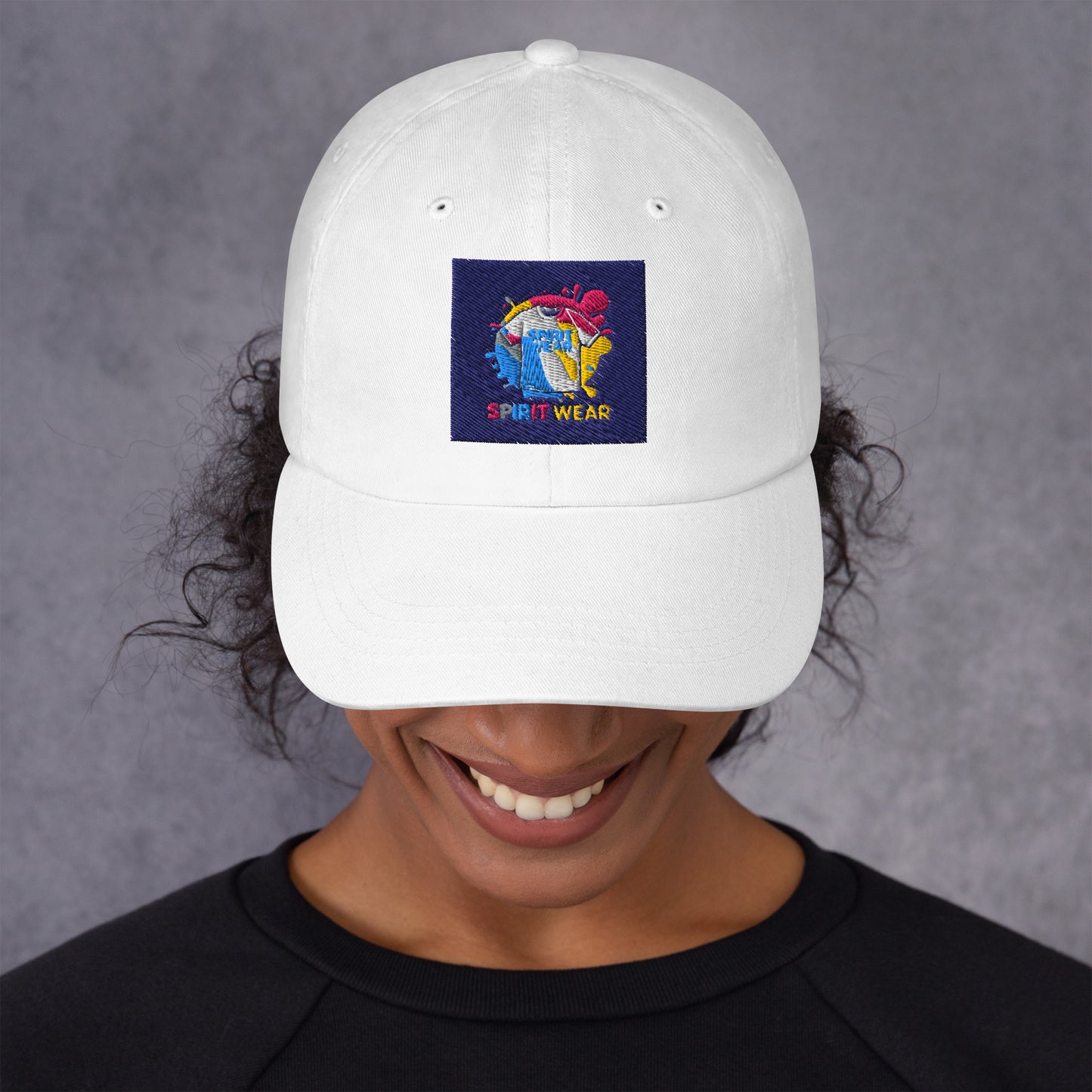 White Christian ball cap by Spirit Wear with colorful embroidered logo worn by smiling person