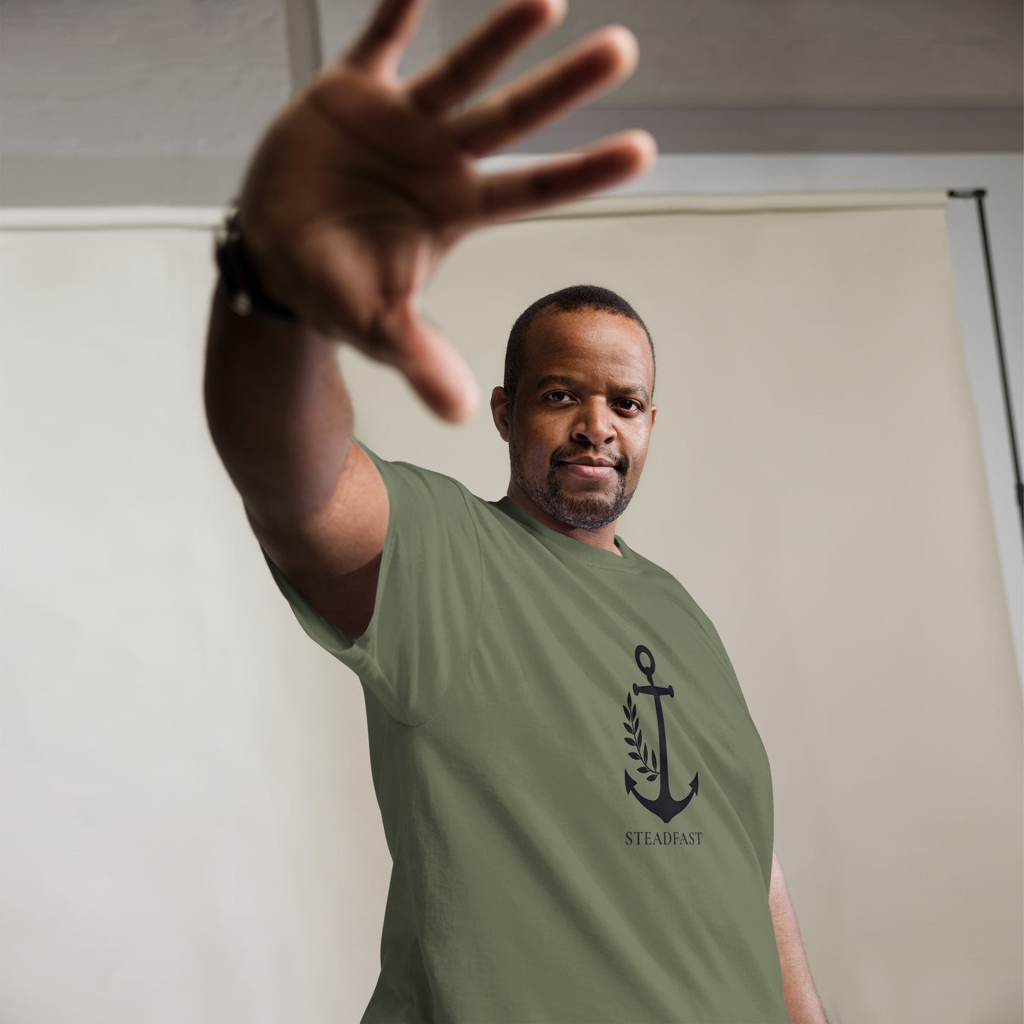 Spirit Wear Christian t-shirt withchor design olive green anchor Steadfast graphic on male model reaching forward