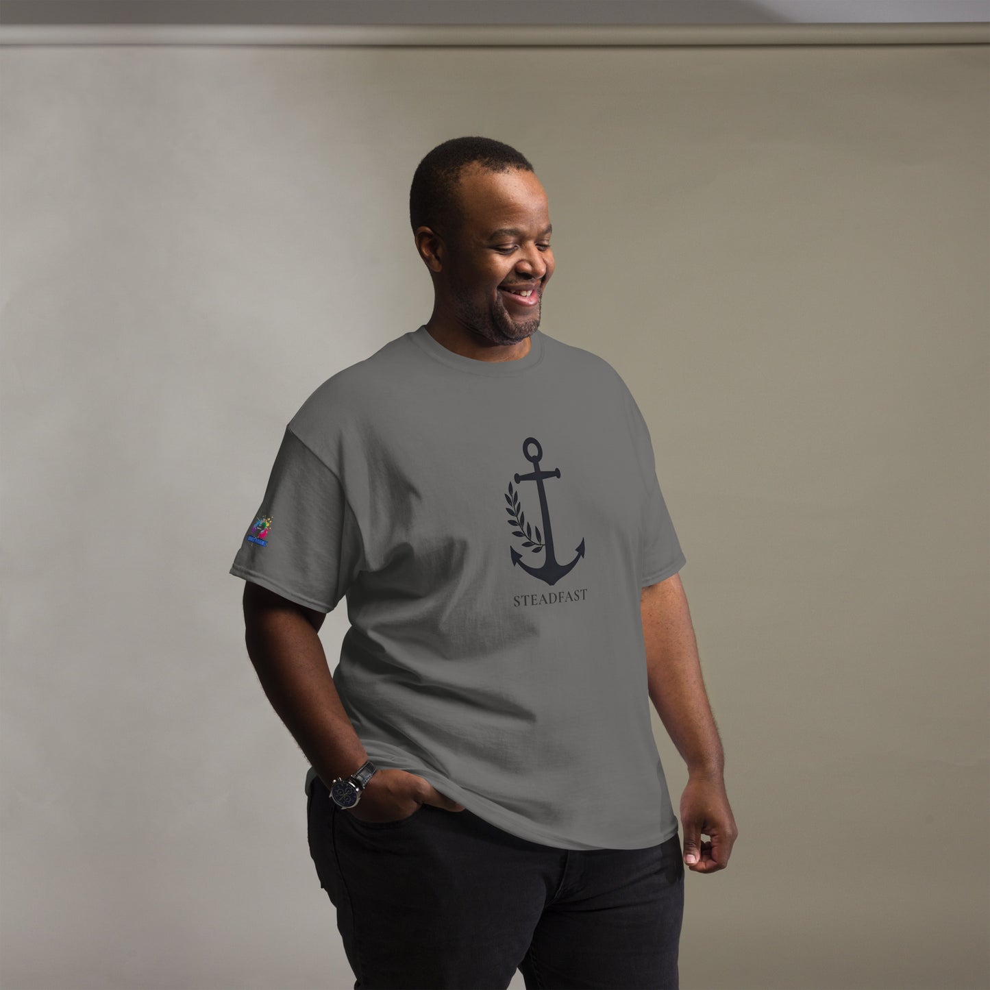 Spirit Wear model wearing gray Christian t-shirt withchor design showing anchor emblem and steadfast text