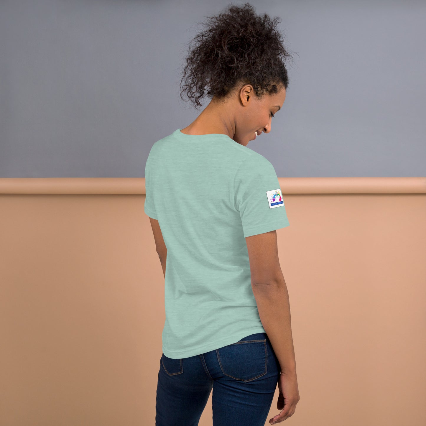 Woman wearing light green Spirit Wear Christian anchor shirt for men and women shown from back with sleeve logo