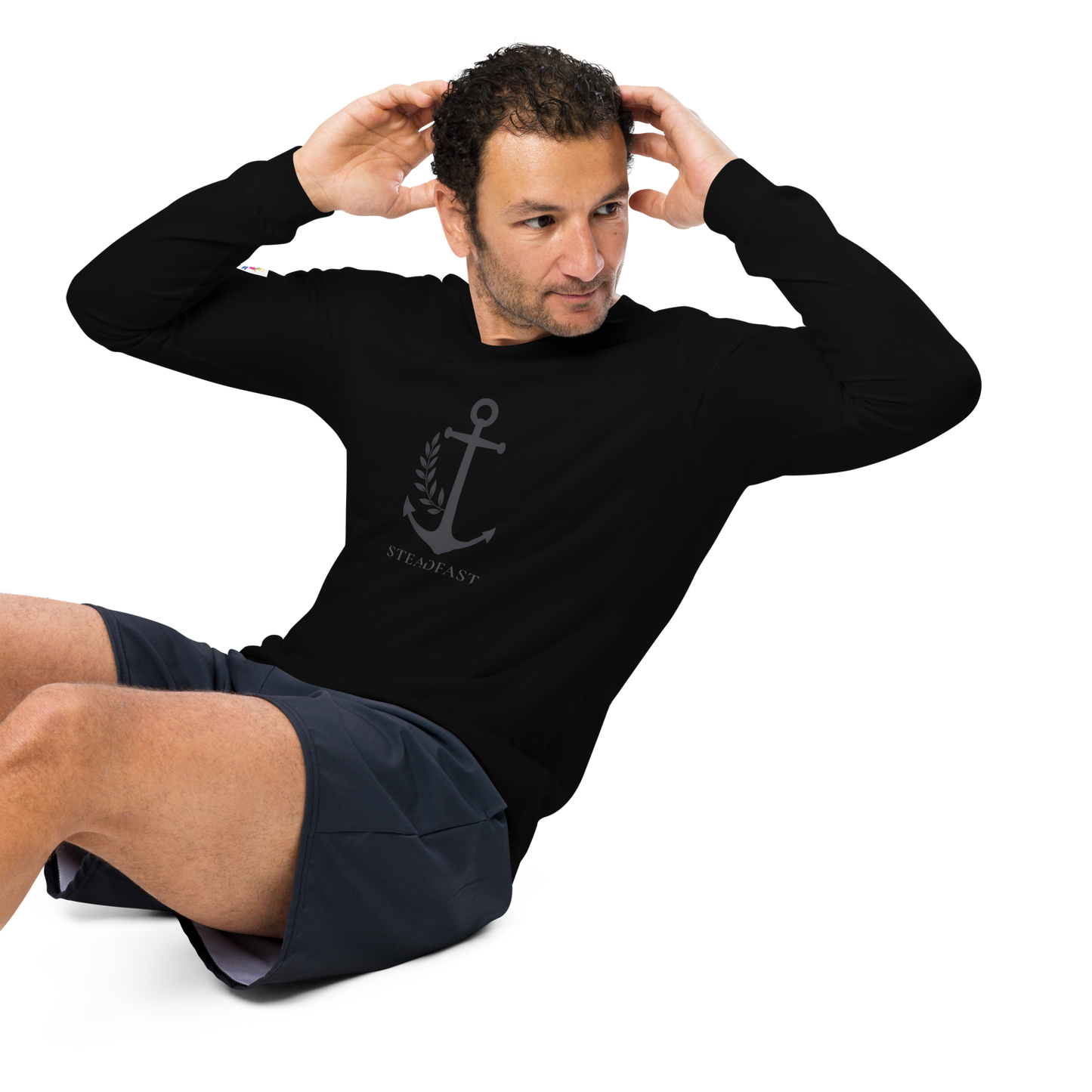 Man exercising in black inspirational long sleeve t-shirt with anchor graphic and athletic shorts by Spirit Wear
