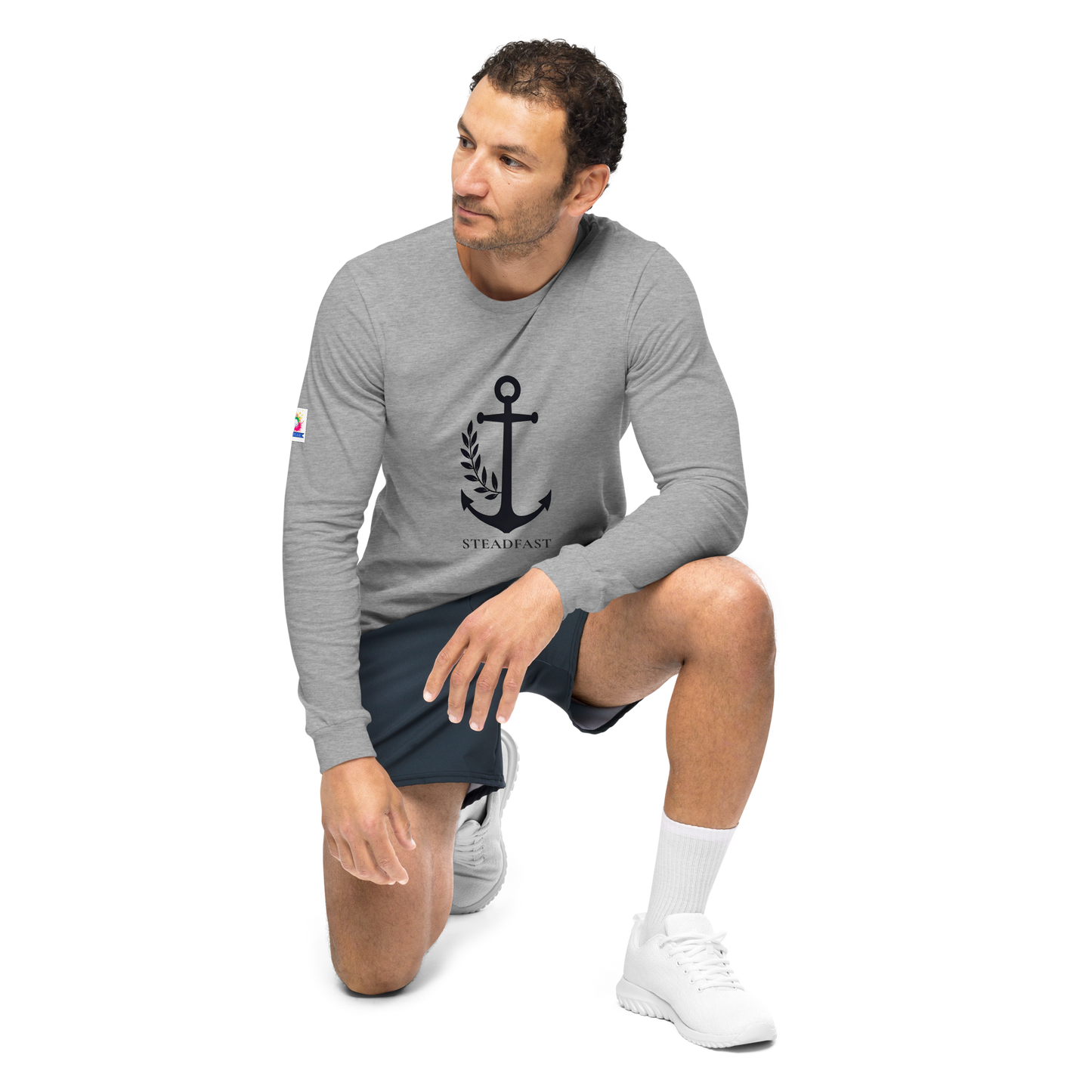 Male model kneeling in gray inspirational long sleeve t-shirt with black anchor graphic by Spirit Wear