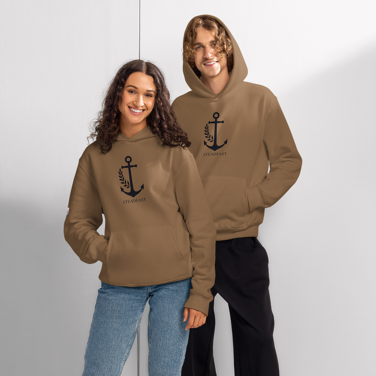 Two models wearing brown oversized religious hoodie for adults with anchor emblem on chest for casual wear