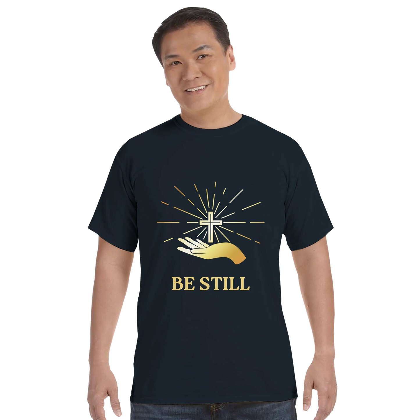 Christian graphic t-shirt featuring a hand holding a cross with the text Be Still