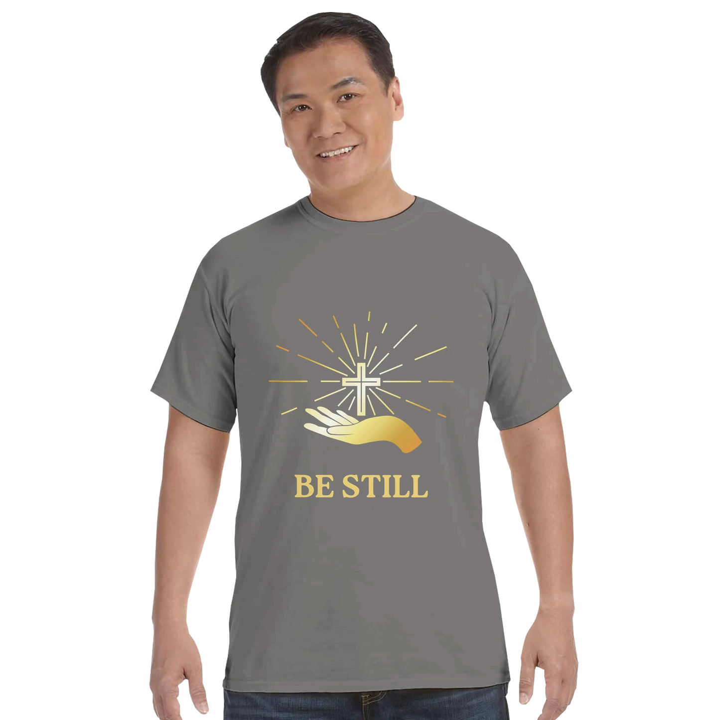 Christian graphic t-shirt in gray featuring a hand, cross, and the text Be Still