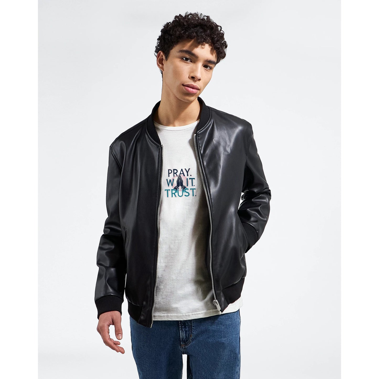 Young model wearing Christian inspirational t-shirt under a black bomber jacket for stylish casual look