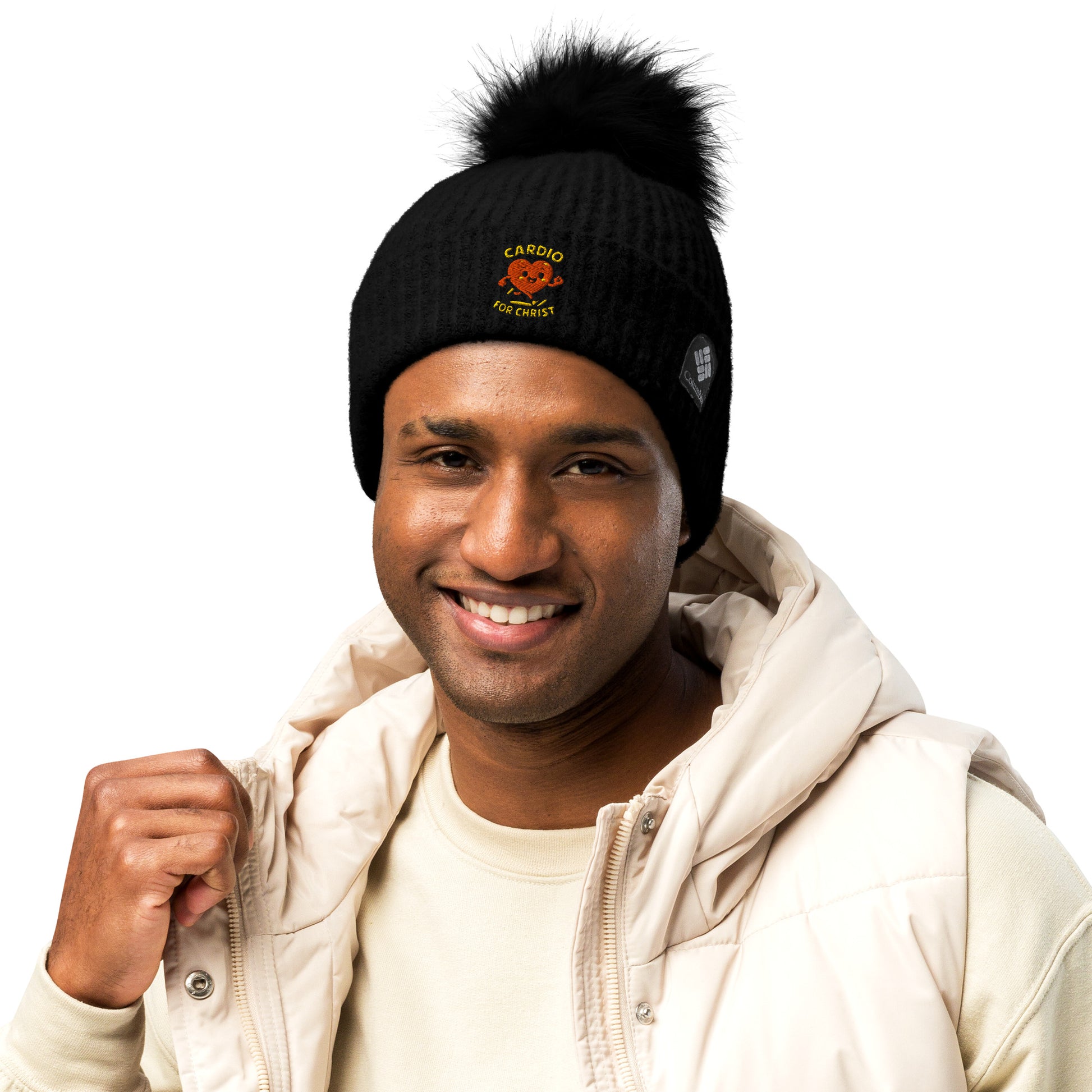 Spirit Wear black Christian winter beanie with pom-pom and cardio for Christ logo on a smiling man