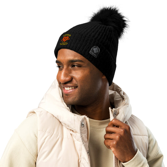 Man wearing black Christian winter beanie with pom pom and embroidered heart design by Spirit Wear