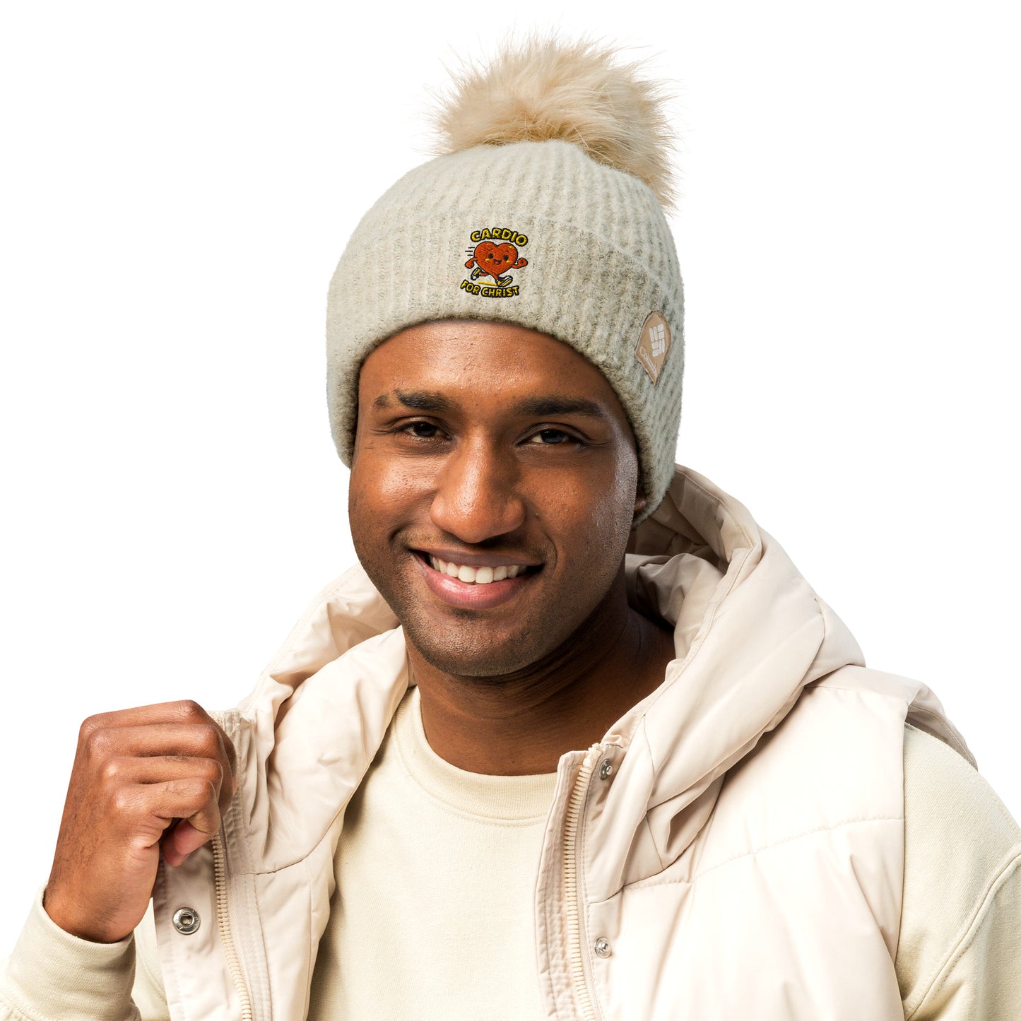 Man wearing a beige Christian winter beanie with pom pom and heart design from Spirit Wear