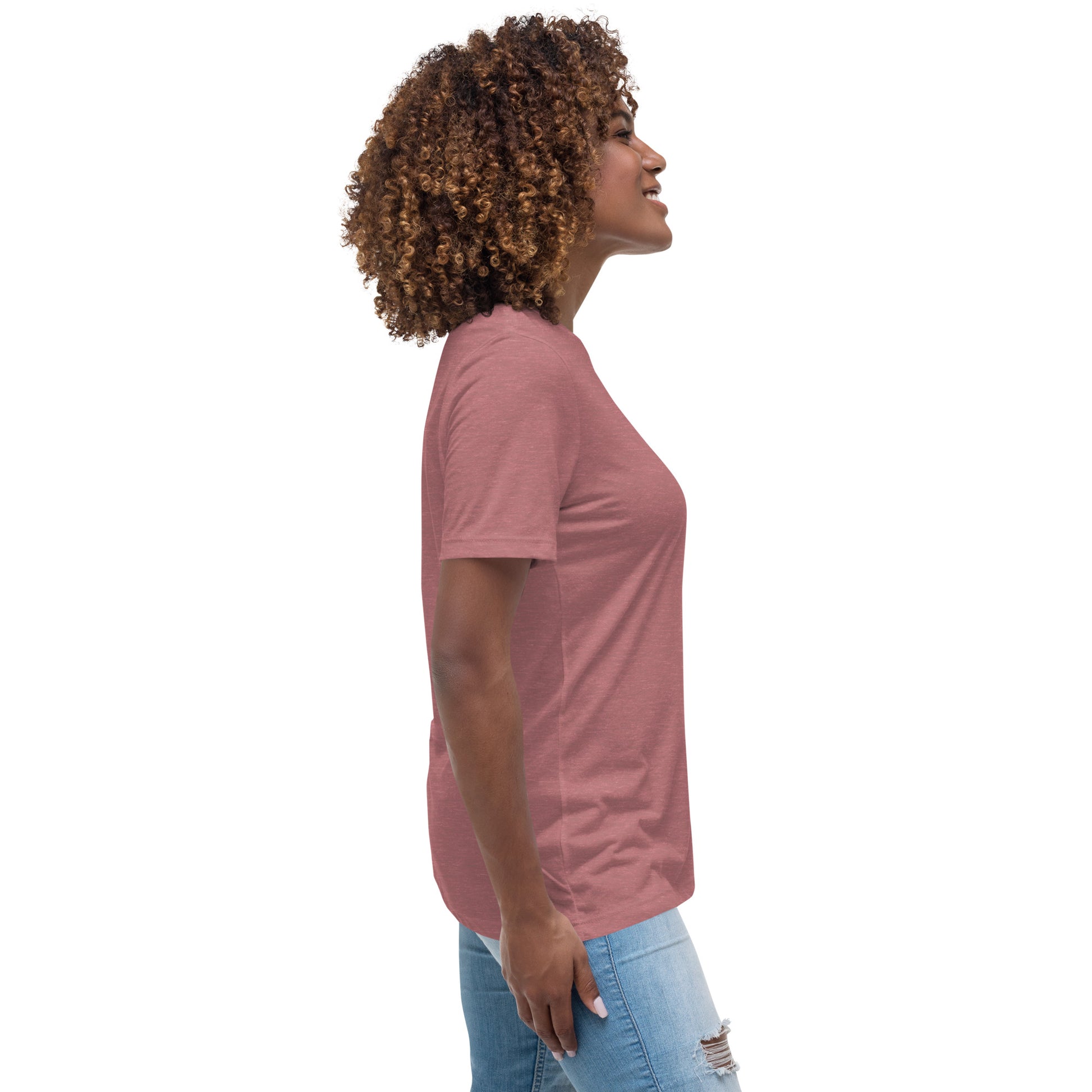 Side view of woman wearing a pink inspirational graphic tee for women paired with ripped light blue jeans