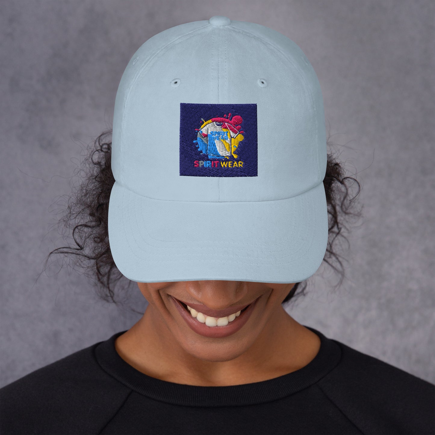Spirit Wear Christian ball cap in light blue with colorful logo worn by smiling person
