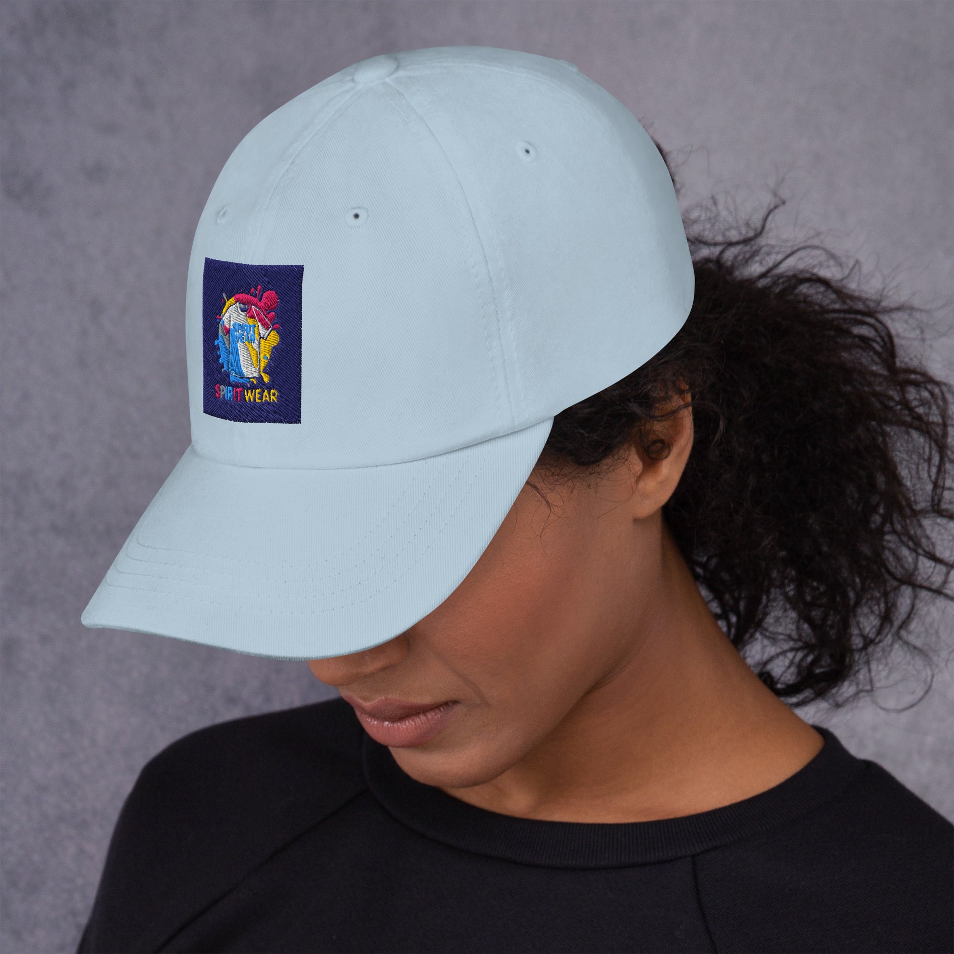 Light blue Christian ball cap by Spirit Wear with colorful embroidered logo worn by woman