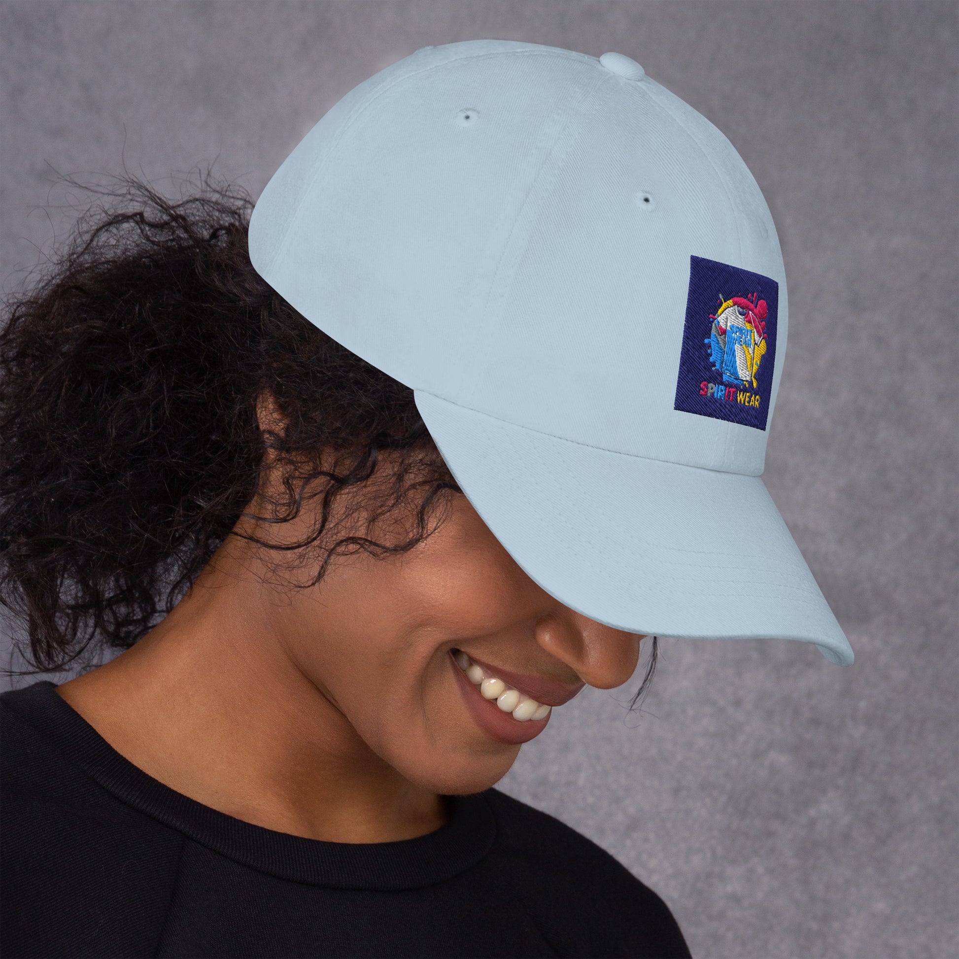 Woman wearing light blue Christian ball cap with colorful Spirit Wear logo patch