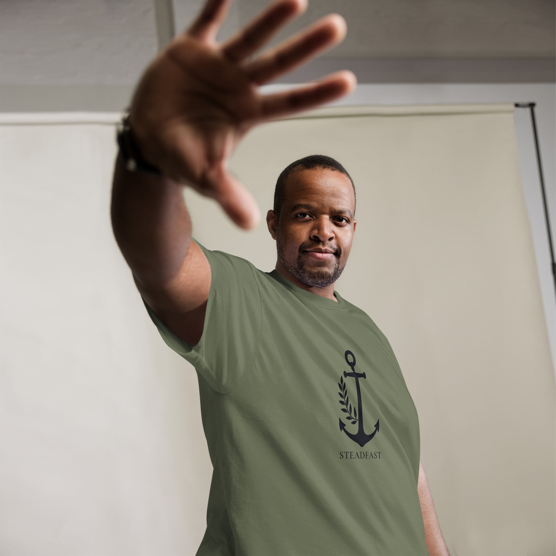 Spirit Wear Christian t-shirt withchor design olive green anchor Steadfast graphic on male model reaching forward