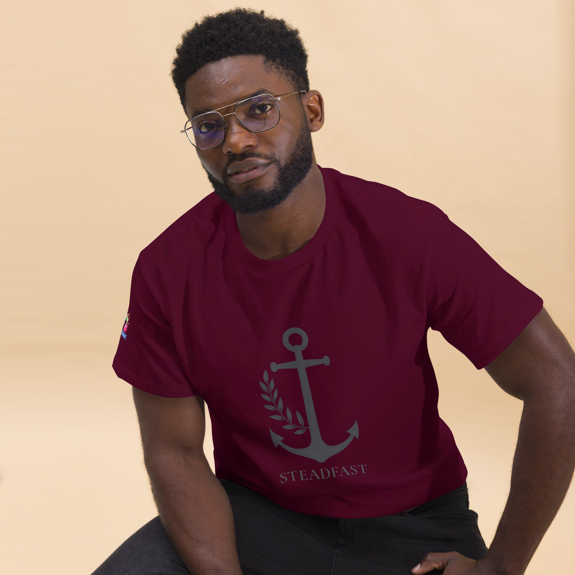 Model wearing maroon Spirit Wear Christian t-shirt withchor design. Anchor and STEADFAST print on front