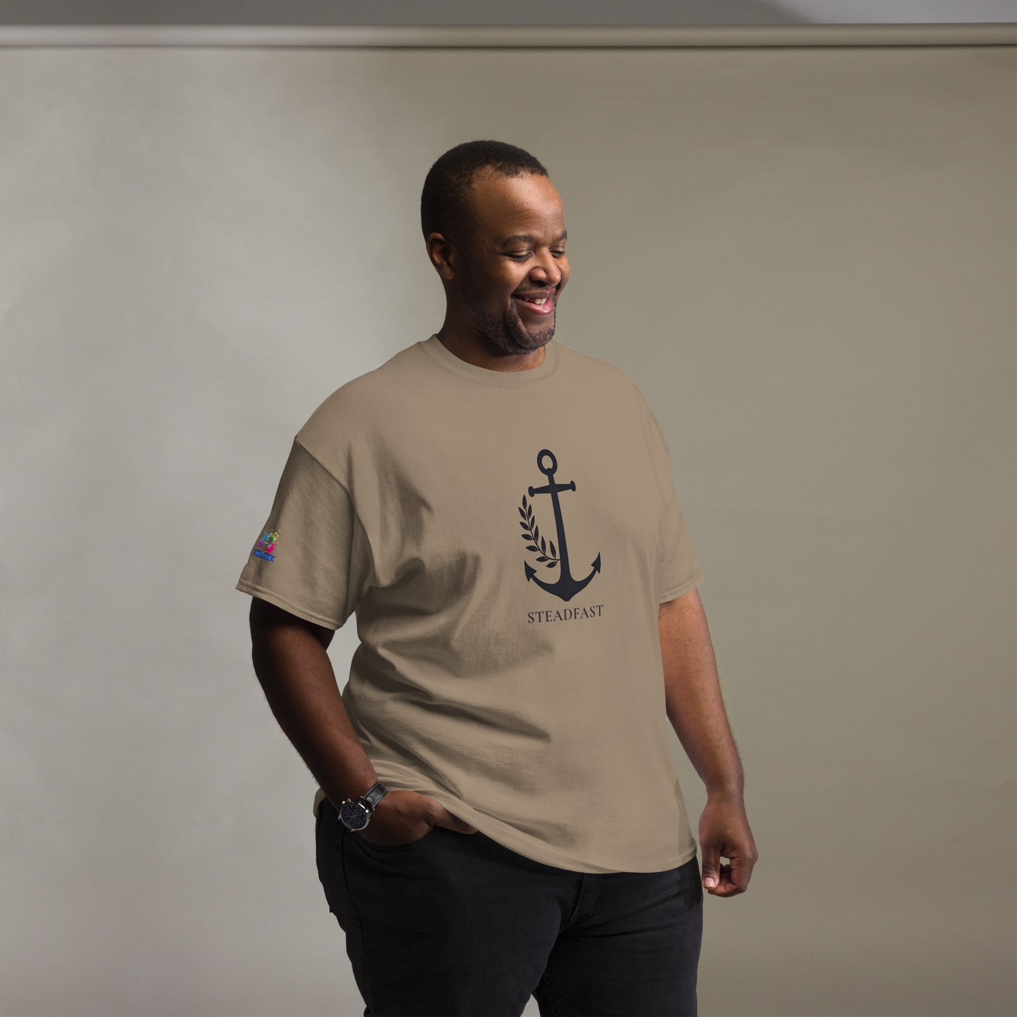Spirit Wear Christian t-shirt withchor design. Smiling man wearing tan tee with navy anchor graphic