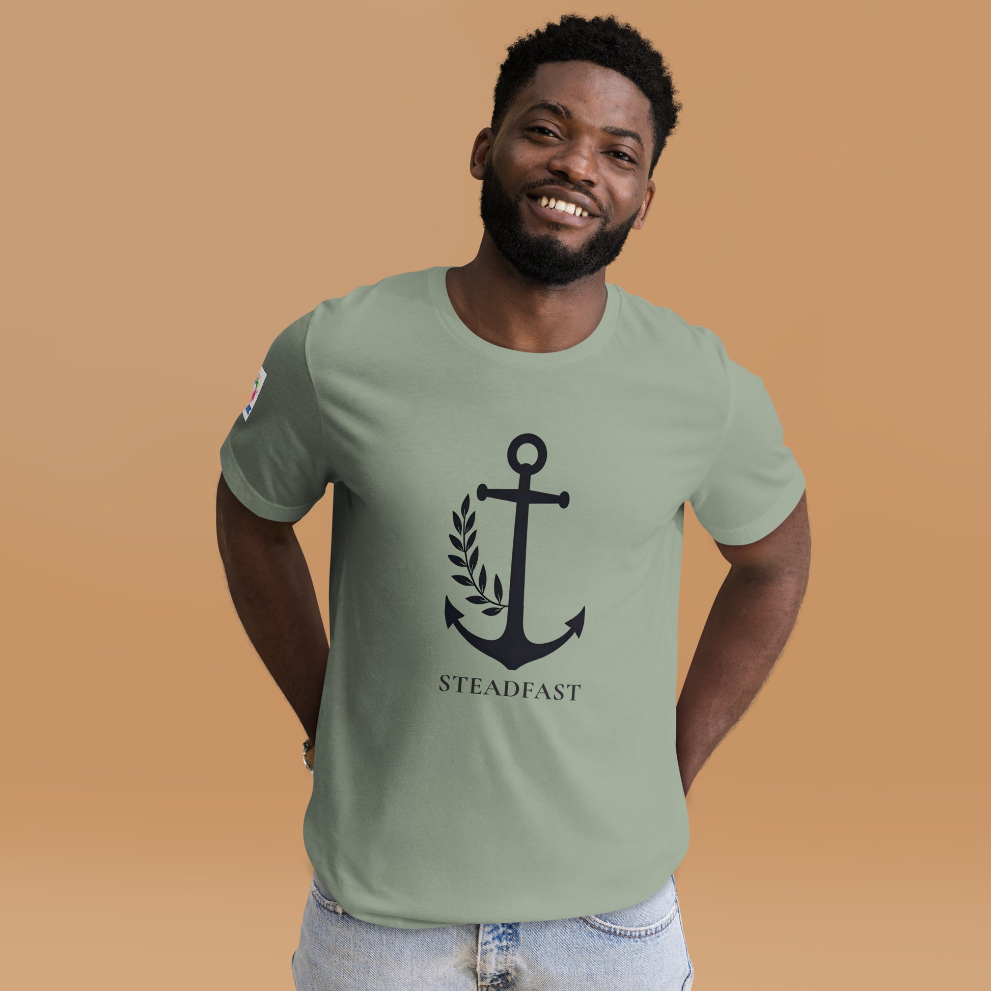 Smiling man wearing Spirit Wear Christian anchor shirt for men and women. Sage tee with black anchor and steadfast text