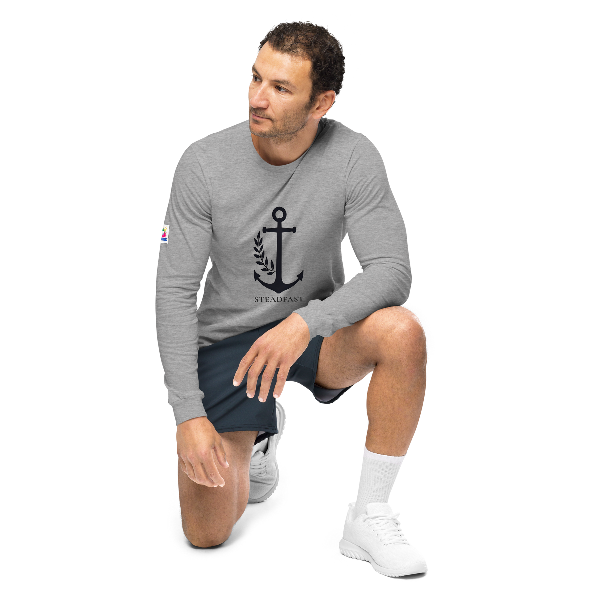 Male model kneeling in gray inspirational long sleeve t-shirt with black anchor graphic by Spirit Wear