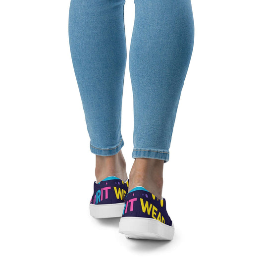 Spirit Wear women's slip-on canvas shoes in colorful design with white soles worn with blue jeans