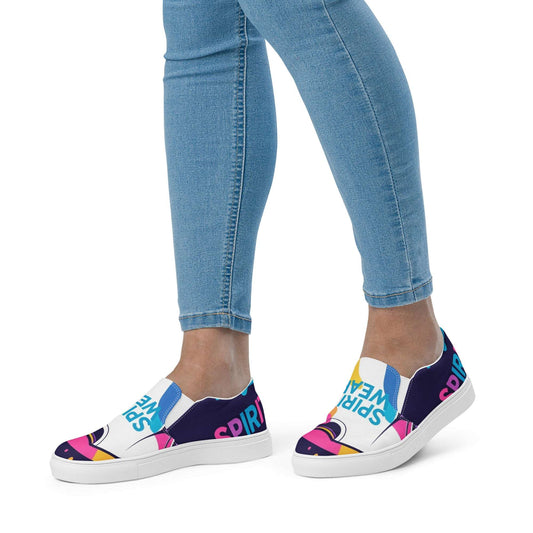 Spirit Wear women's slip-on canvas shoes with colorful graphic design worn with blue jeans